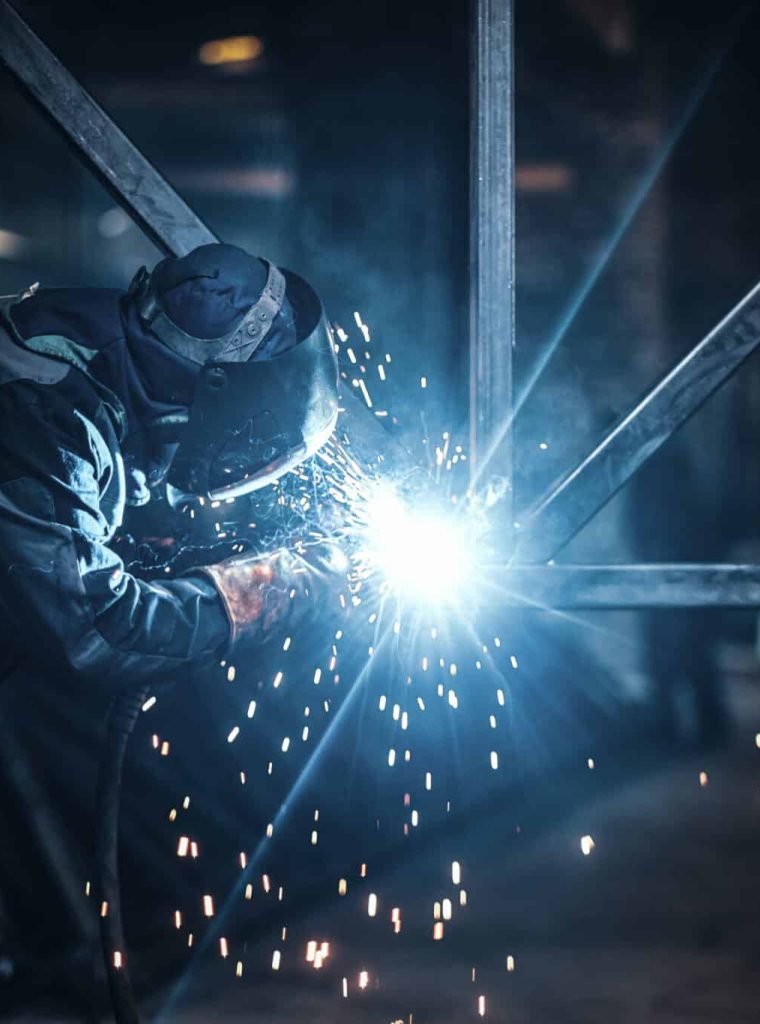 Welding work with metal construction at busy metal factory